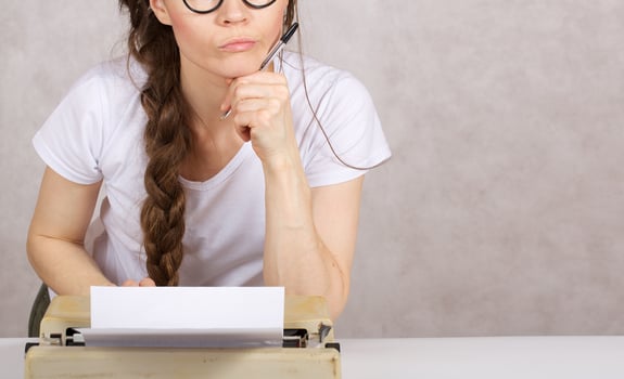 Young lady  with typing machine. Closeup photo