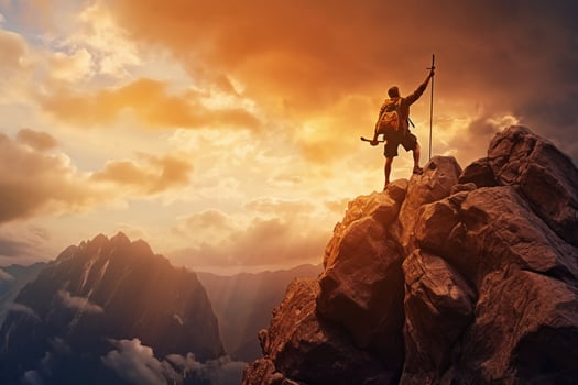 Successful hiker hiking a mountain pointing to the sunset. photo