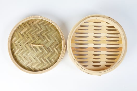 Wooden bamboo dim sum steamer on white background photo