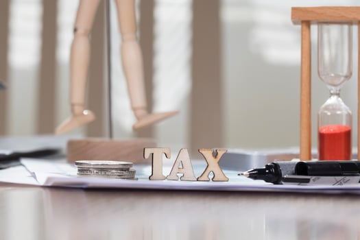 Word TAX composed of wooden letters. Closeup photo