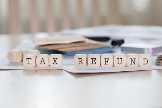 Word TAX REFUND is composed of wooden letters. photo