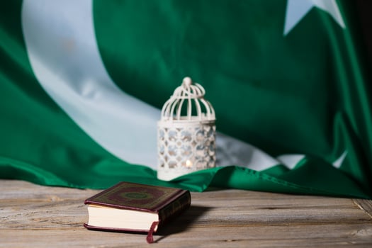 Sacred book of Quran on a wooden surface. photo
