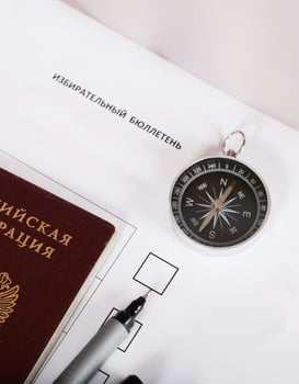 Magnetic compass, Russian pass and black pen on ballot paper. photo