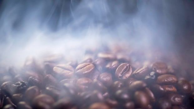 Coffee beans roasting with smoke,  selective focus, and soft focus. photo