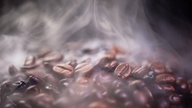 Coffee beans roasting with smoke,  selective focus, and soft focus. photo