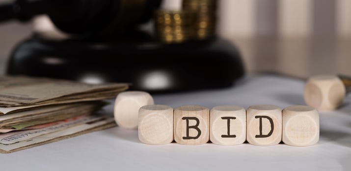 Word BID composed of wooden dices. photo