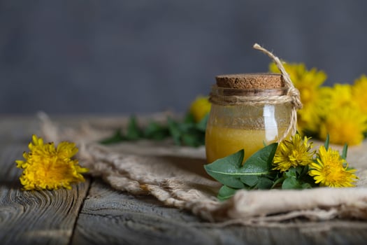 Dandelion  honey in a glass bottle on a piece of sackcloth. photo