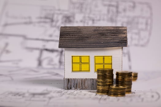 Small paper house on a technical drawing. photo