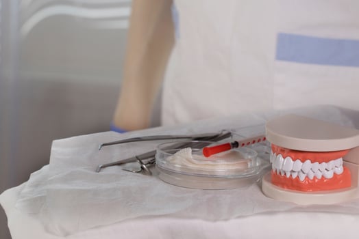 Sterile cotton napkins and stomatological tools on a table. Closeup photo