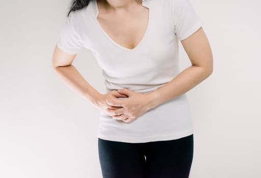 Stomachache women Hands holding the left stomach. photo