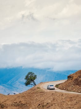 Mountain serpentine road loop. Morning mountain valley with a serpentine road. Silver car on a mountain serpentine. photo