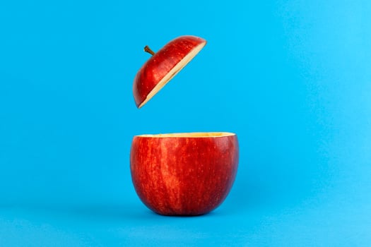 Health Red Cut Apple floating top slice juice drink idea concept on blue background photo