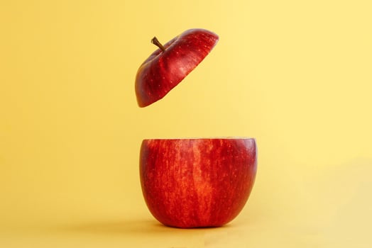Healthy Red Cut Apple floating top slice juice drink idea concept on yellow background photo