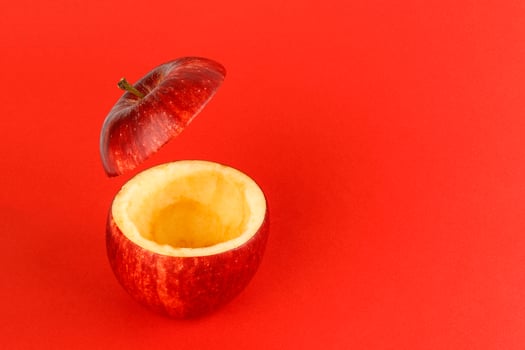 Healthy Red Cut Apple floating top slice juice drink idea concept on red background photo