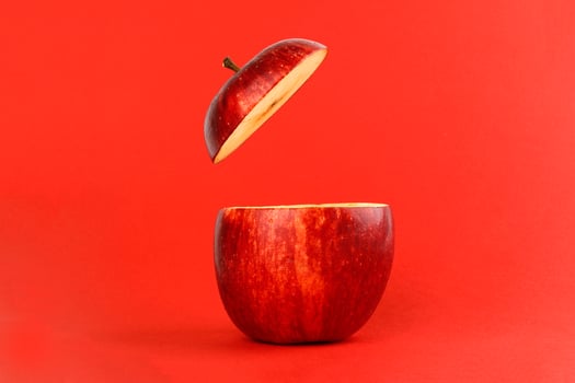 Healthy Red Cut Apple floating top slice juice drink idea concept on red background photo
