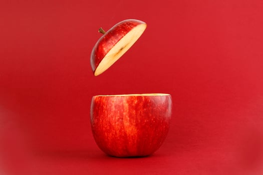 Healthy Red Cut Apple floating top slice juice drink idea concept on red background photo
