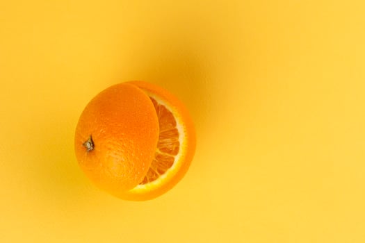 Healthy Orange Cut floating top slice juice drink idea concept on yellow background photo