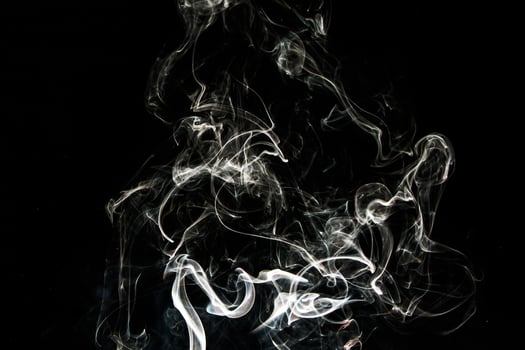 Smoke effect texture. Isolated background. Black and dark backdrop. Smokey fire and mistic effect. photo