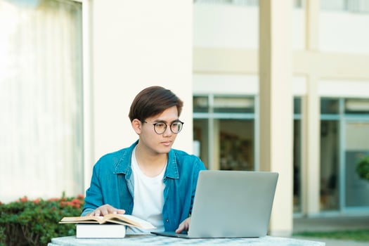 Student studying outdoor using laptop. photo