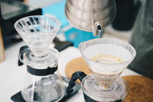 Hand drip coffee, Barista making brew coffee by pouring water on ground coffee with filter. photo