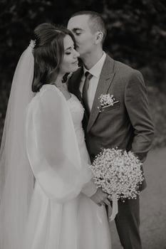 Im so happy that I met you. Shot of a happy young couple standing together on their wedding day. Beautiful buket. photo