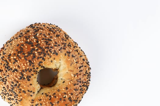 Toasted sliced black seed sesame bagel bread on white background photo