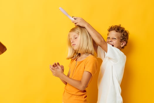 a boy combing a girl's blonde hair photo