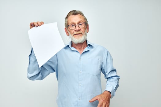 elderly man holding a sheet of paper copy-space posing isolated background photo
