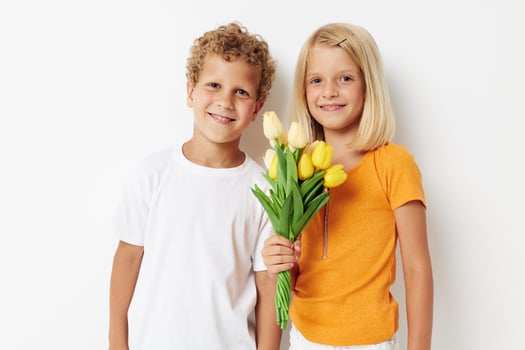 Portrait of cute children holiday friendship with a gift Yellow flowers lifestyle unaltered photo