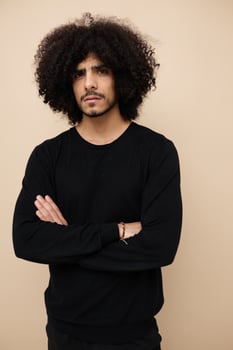 handsome man in a black sweater hand gesture Lifestyle unaltered photo
