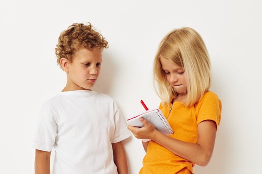 cheerful children stand next to notepad pencil drawing emotions color background unaltered photo