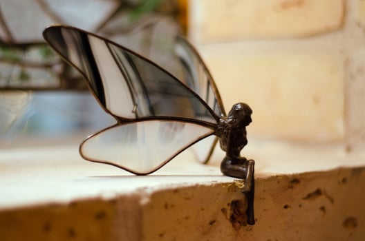Metal Fairy sitting on a brick photo