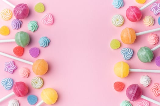 Sweet lollipops and candies on pink background photo