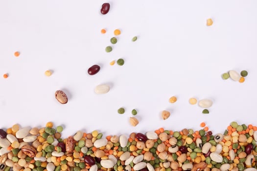 Mixed beans multi grain colorful mixture horizontal line frame border copy text space on white background photo
