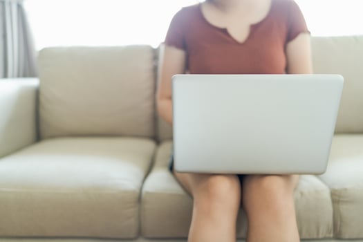 woman using computer laptop for work online at living room. photo