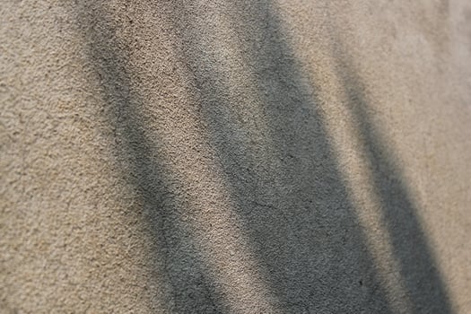 Cement and brick wall texture background, sun rays on the cement wall surface, smooth cement wall backdrop photo
