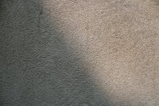 Cement and brick wall texture background, sun rays on the cement wall surface, smooth cement wall backdrop photo