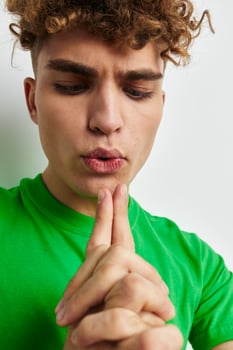 handsome guy in green t-shirts emotions posing isolated background photo