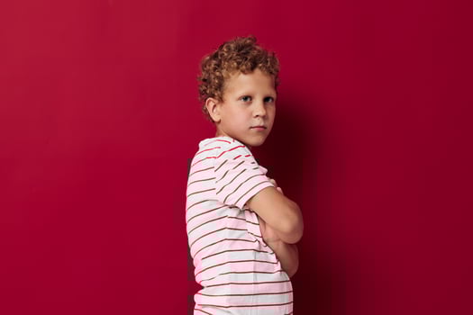 Cheerful boy in casual clothes posing emotions red background photo