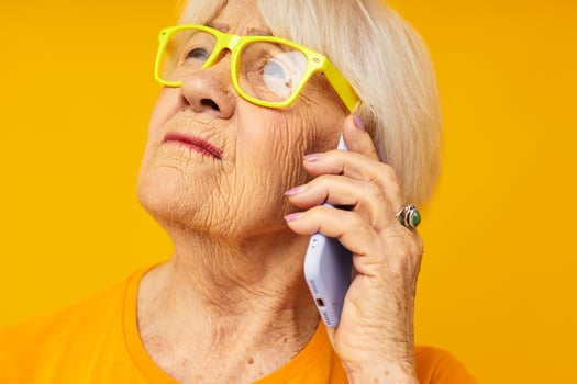elderly woman fun talking on the phone close-up emotions photo
