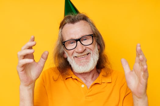 Photo of retired old man in a yellow t-shirt with a cap on his head fun cropped view
