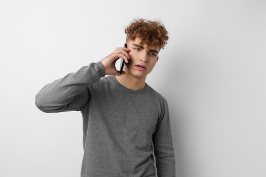 handsome young man with a phone in hand communication isolated background photo