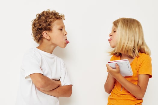 picture of positive boy and girl stand next to notepad pencil drawing emotions lifestyle unaltered photo