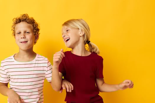 Cute stylish kids cuddling fashion childhood entertainment on colored background photo