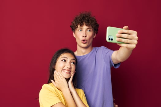 young man and girl take a selfie posing hug isolated background photo