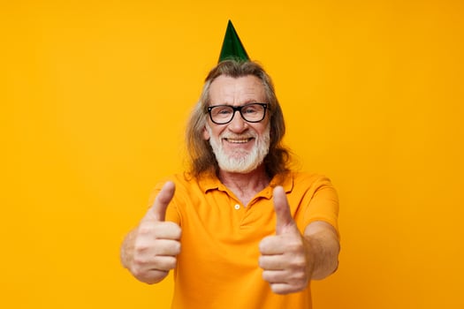 Senior grey-haired man wearing glasses green cap on his head holiday emotions monochrome shot photo
