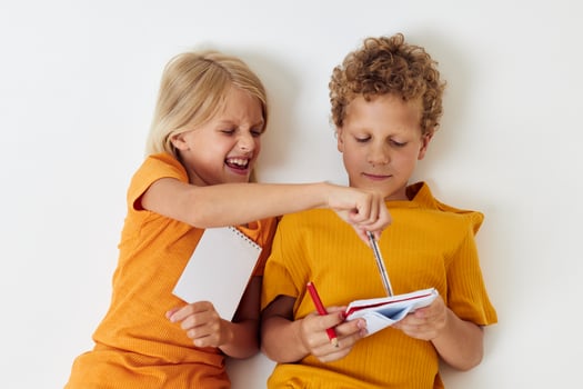 Cute stylish kids drawing in notebooks lying on the floor childhood lifestyle unaltered photo