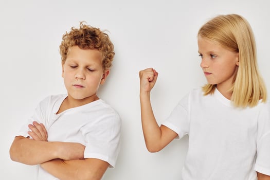 Boy and girl in white T-shirts are standing next to isolated background photo