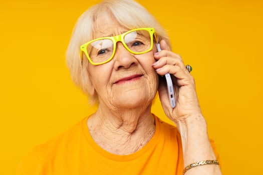 smiling elderly woman fun talking on the phone isolated background photo