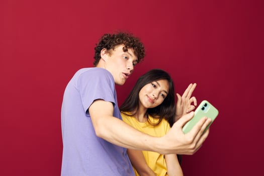 teenagers in colorful T-shirts with bags Shopping red background unaltered photo